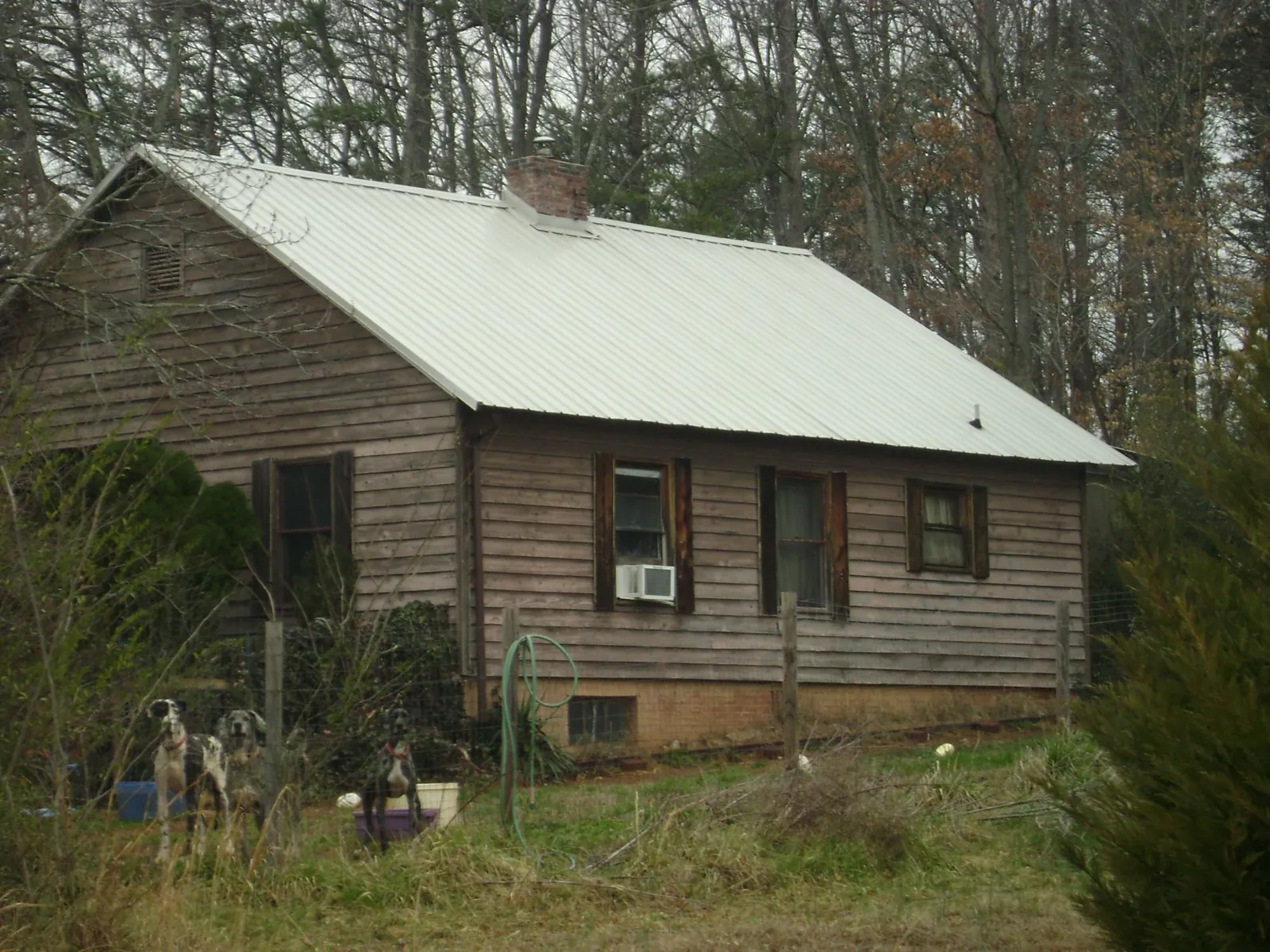 White metal roof on an old wood sided farmhouse, from a Metal Roof Installation job in Lulu